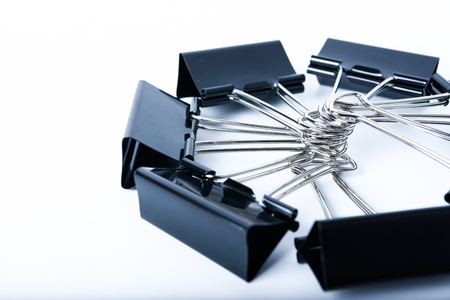 Black old metal binder paper clip for document on white backgroundの写真素材