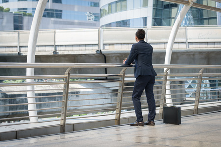 businessman standing and a bag office wating time work dayの写真素材