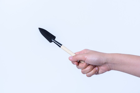 hand holding  mini garden tool on white backgroudの写真素材