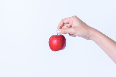 hand holding Red fresh apple shred
 on white backgroundの写真素材