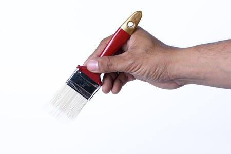 hand on red paintbrush isolated on white backgroundの写真素材