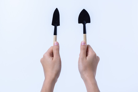 hand holding  mini garden tool on white backgroudの写真素材