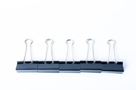 Black old metal binder paper clip for document on white backgroundの写真素材