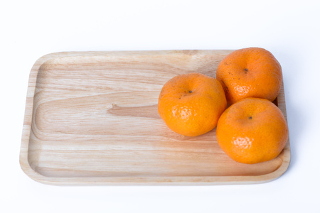 Orange on  wood tray container with white backgroundの写真素材