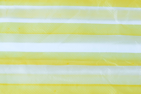 texture of Yellow striped plastic bag on white backgroundの写真素材