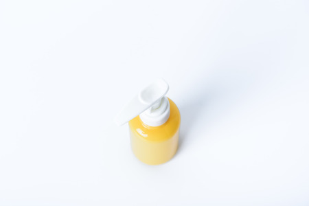 plastic yellow bottle spray on white backgroundの写真素材