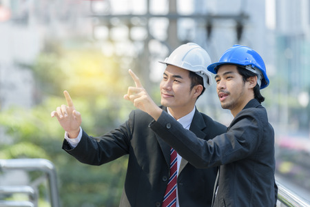 businessman and foreman talking about building structuresの写真素材