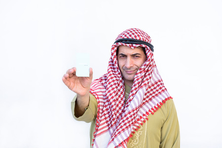 beautiful modern muslim business  young man portrait show cadit card on white backgroundの写真素材