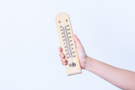 hand holding  wood Thermometer on white backgrondの写真素材