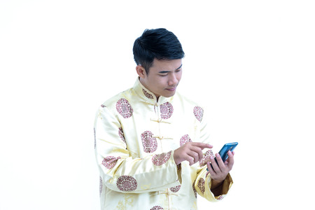 China young man,Asian man wear  dress chinese style cheongsam and holding mobile phoneの写真素材