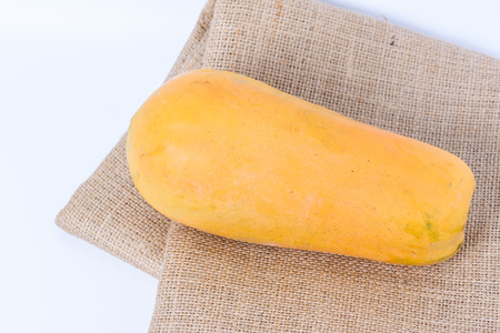 ripe papaya with Hessian sackcloth woven  on white backgroundの写真素材