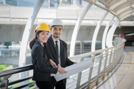 architecture worker man and woman discussion about building blueprintの写真素材