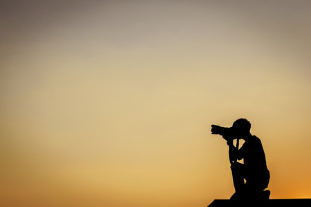 silhouette photography take photo on top of roof barの写真素材