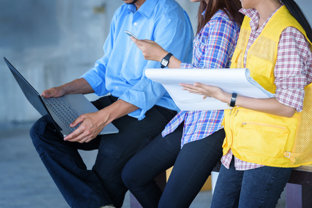 construction engineer hand holding blueprint inside building structureの写真素材