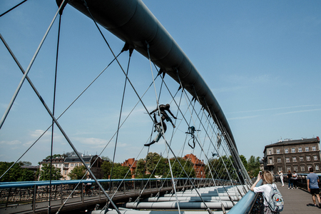 Bridge in Krakow via Vistula. Sculptures on the bridge. Statues on ropes. An interesting place was Krakow. Polskaの写真素材