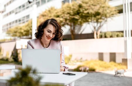 Stylish woman reading a newspaper. Successful girl with a notebook. Business woman. Stylish girl...