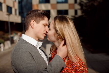 Concept of love relationships man and woman. Lovely couple walking in the big city, hugging, kissing and enjoying each other.Young loving couple in warsawの写真素材