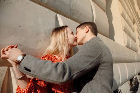 Concept of love relationships man and woman. Lovely couple walking in the big city, hugging, kissing...