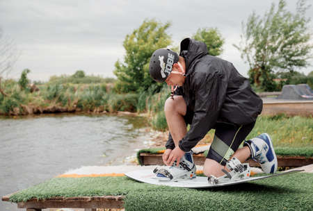 Bielawa, Polska. 03/06/2020 Wawa Wake. Bielawa, Polska. 03/06/2020 Wawa Wake. Athlete guy rides on a wakeboard. A man in sportswear swims on a lake in a wakeboard park. Sportのeditorial素材