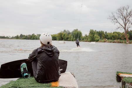 Photo for Bielawa, Polska. 03/06/2020 Wawa Wake. Young female athlete glides on water skis on the waves on the lake. - Royalty Free Image