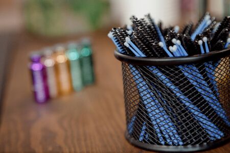 Organizer with brushes and makeup sticks. The organizer is in focus and the brushes are out of focus.の写真素材