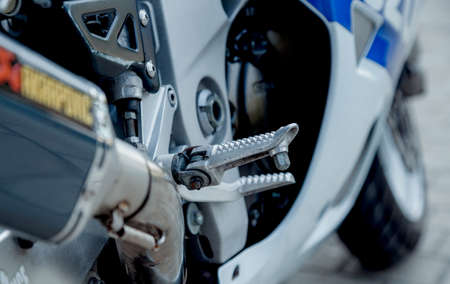 Motorcycle parked in the streets. Foot rests on the front of the motorcycle.の写真素材