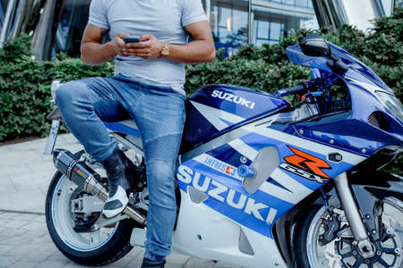 Warsaw. Poland. 07/29/2020. Warsaw Spire. Guy on with a blue sports motorcycle Suzuki. Sport