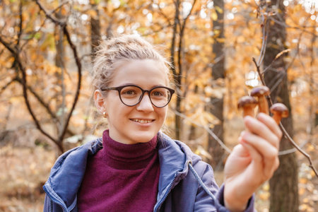 Mushrooms in hands. Picking mushrooms. Gifts of the forest. Hands and mushrooms. Leg and hat.の写真素材