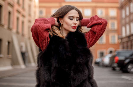 Elegant girl walk in a winter city. Beautiful lady with blond hair. Portrait of beautiful blond...