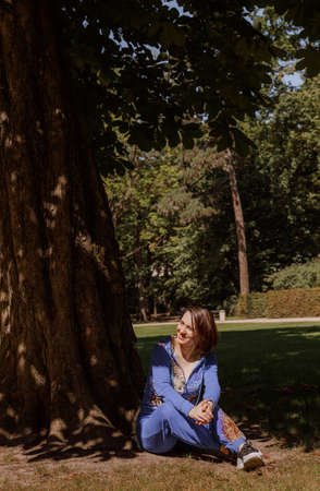 Portrait of an attractive woman gardener. Beautiful European woman in the garden near the flowers. Senior woman without makeup in the garden. Warsaw. Poland.の写真素材