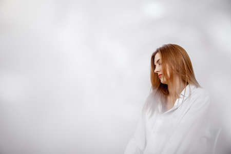 Businesswoman confident portrait. Fashion shoot of young sexy in white studio street style. Fashion...