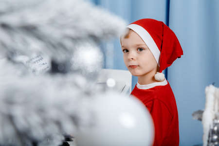 Boy in santa costume. Kid concept for merry Christmas and happy new year celebration. Small boy...