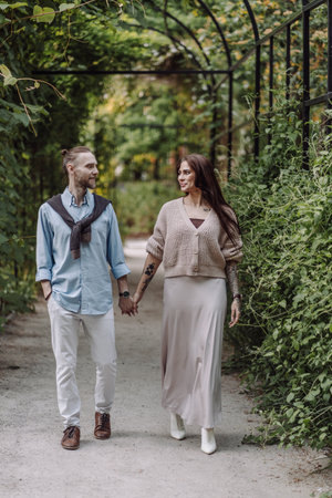 Copy space. Happy couple are laughing. Happy guy and girl. Lovers enjoy each other in the evening park. Young couple strolling in the park. Happy romantic moments of lovely couple in park during dating.の写真素材