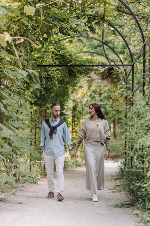 Copy space. Happy guy and girl. Lovers enjoy each other in the evening park. Young couple strolling in the park. Happy romantic moments of lovely couple in park during dating.の写真素材