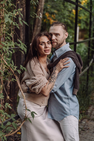 Love, hug and happy with couple in park for romance, bonding and summer vacation. Loving young couple hugging and smiling together on nature background.の写真素材