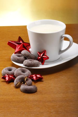 milk and cookies for santa on table with gold backgroundの写真素材