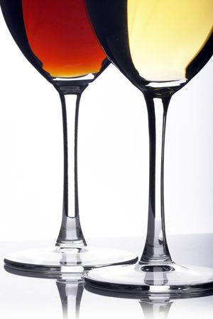 Glass of red and white wine on a white background and with soft shadowの写真素材