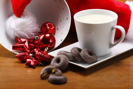 milk and cookies for santa on table with gold backgroundの写真素材