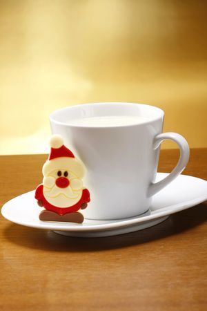 milk and cookies for santa on table with gold backgroundの写真素材