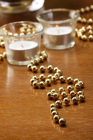 Glasses of champagne with gold background with walnuts, candels and dryed raisinsの写真素材