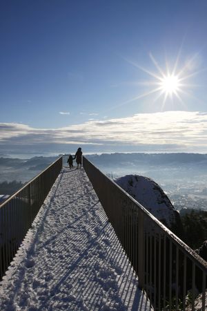 Mother and son on balcony looking at beatiful landscapeの写真素材