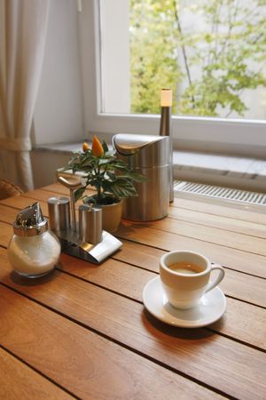 Breakfast table near to the window with a cup of coffeの写真素材