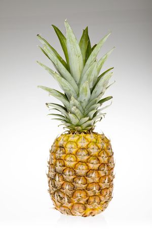 fresh pineapple fruits with green leaf isolated on white background の写真素材