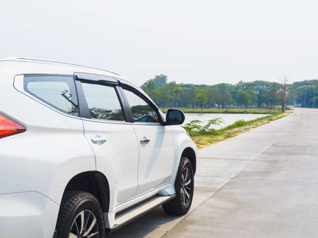 white car parking in the way side the lakeのeditorial素材