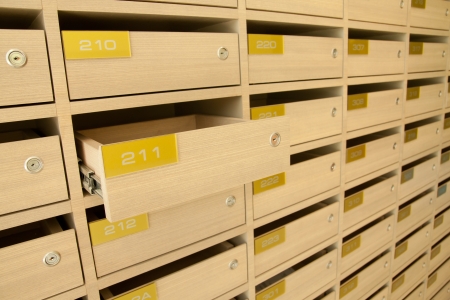 Modern wooden mailbox in apartment