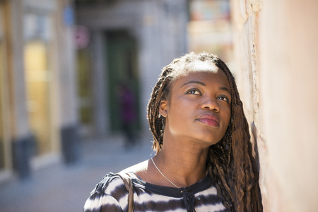 Urban portrait of beautiful african woman pensive meditate.の写真素材