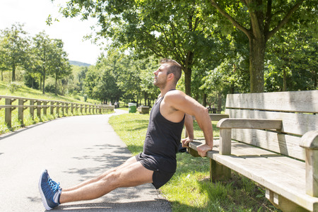 Athletic sport muscular man doing push up, outdoor.の写真素材