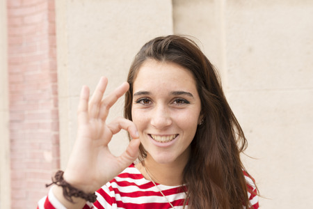 Portrait of happiness smiling woman okey gesture.の写真素材