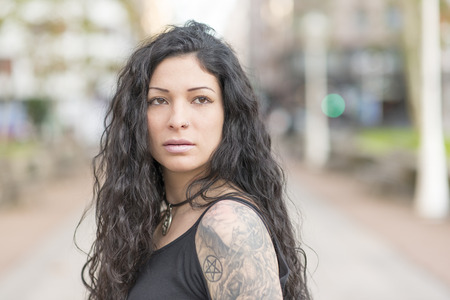 Portrait of beautiful sexy tattooed woman with tattoo looking away.の写真素材