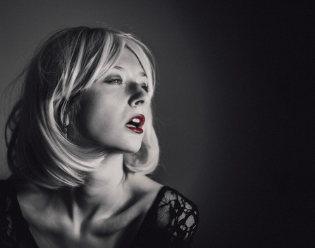 Monochrome close-up portrait of a beautiful, sexy, young girl with blond hair. Fashion Glamour Vogue Concept. の写真素材
